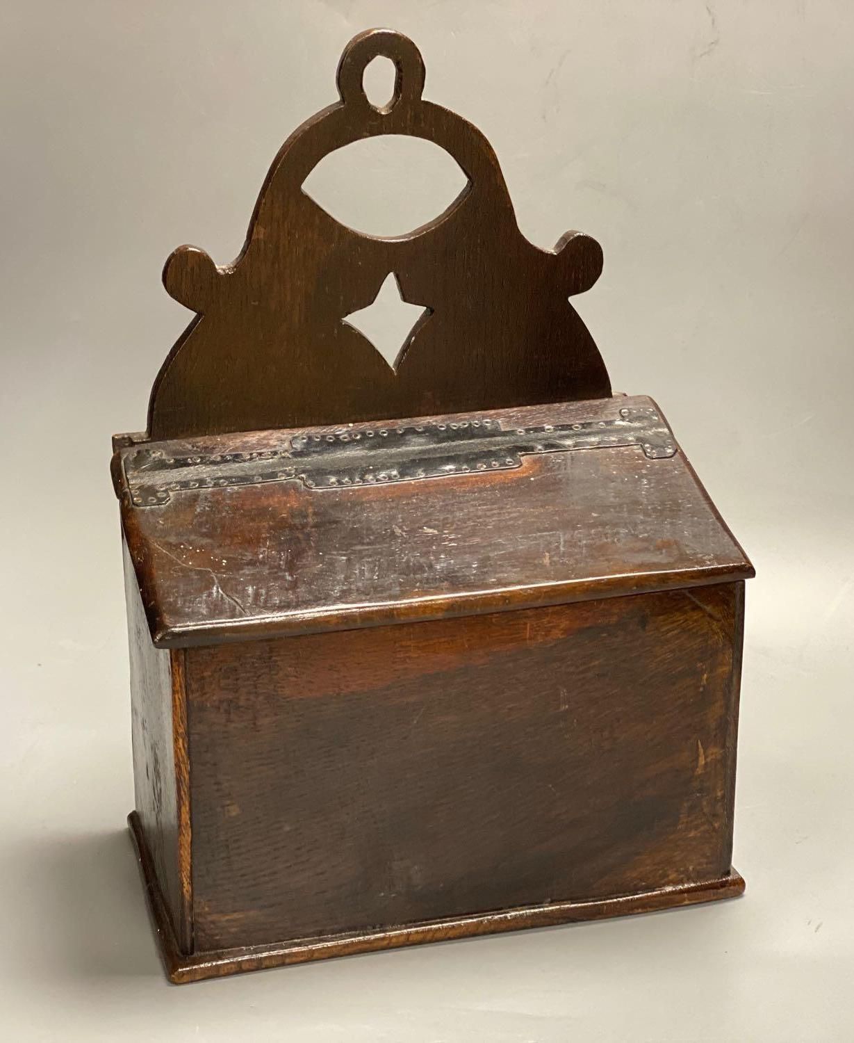 An 18th century oak candle box, cover with studded leather hinge, 28cm wide